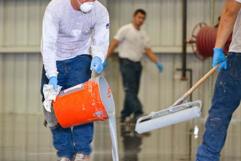 workers installing epoxy flooring