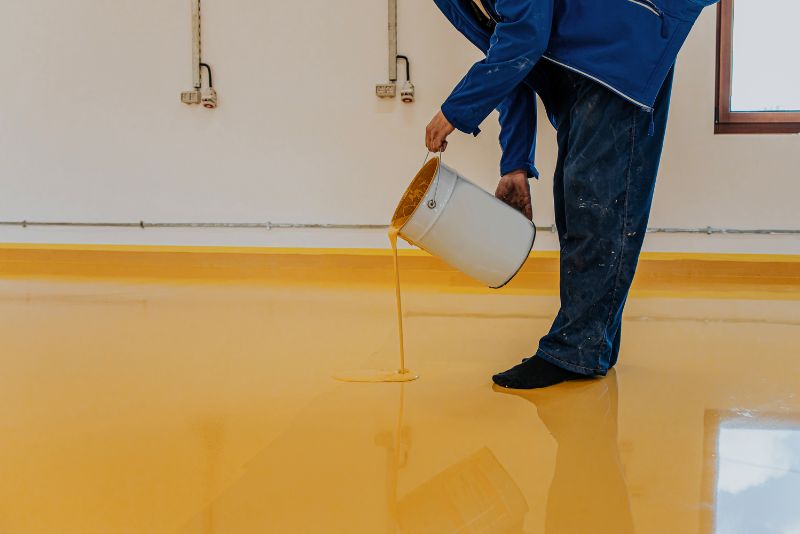 pouring coloured self levelling epoxy mixture